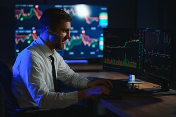 Financial Analysts and Day Traders Working on a Computers with Multi-Monitor