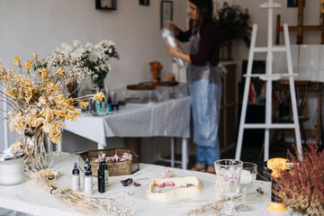 Artisan's workspace with dried flowers and resin crafting materials. Creative home decor, DIY projects, sustainable crafts, floral preservation, handmade art, eco-friendly workshop.