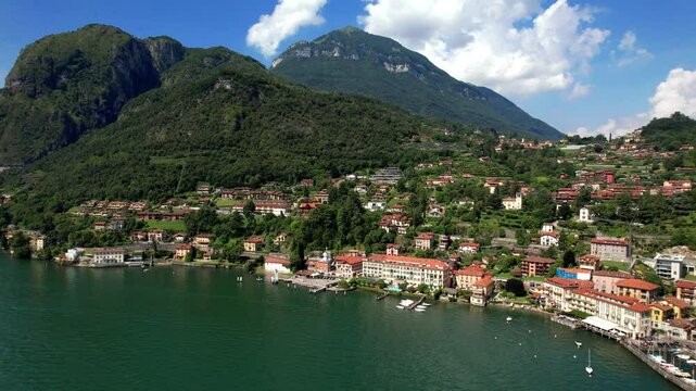 Idyllic lake scenery, amazing Lago di Como. Aerial view of beautiful Menaggio town. Italy, Lombardia. Aerial drone 4k hd video 