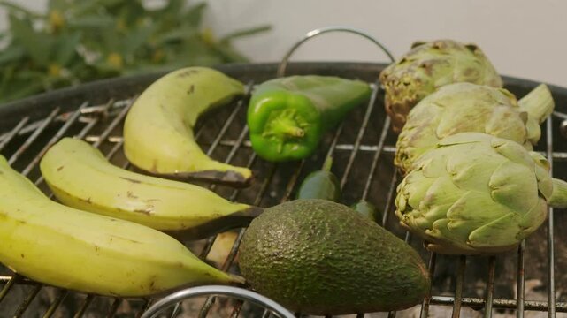 Grilled Banana on fire, latin american vegan grill with avocado and pepper, thai or Ecuadorian Street food. African traditional food on grill. 