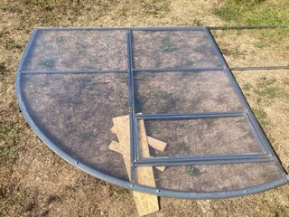 Installation of a metal frame greenhouse with polycarbonate covering