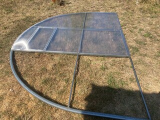 Installation of a metal frame greenhouse with polycarbonate covering