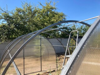 Installation of a metal frame greenhouse with polycarbonate covering