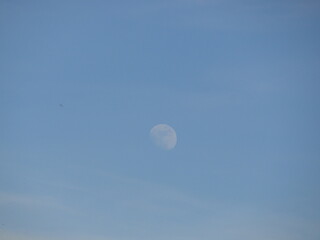 The moon in the blue sky
