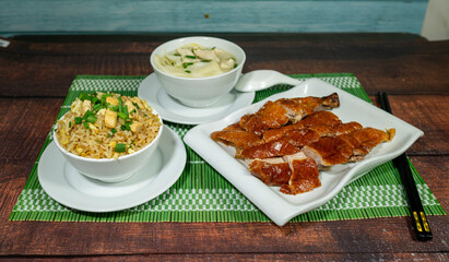 duck roast, served with chaufa rice and wuantan soup. chinese food