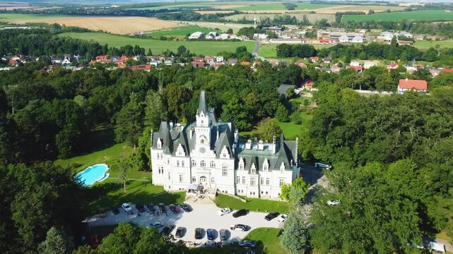 Stunning 4K drone footage of Budmerice Castle in Slovakia. Discover breathtaking aerial views of this picturesque 19th-century castle surrounded by lush greenery and beautiful gardens