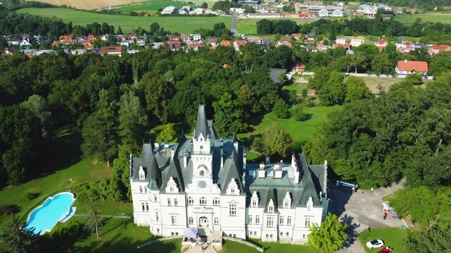 Stunning 4K drone footage of Budmerice Castle in Slovakia. Discover breathtaking aerial views of this picturesque 19th-century castle surrounded by lush greenery and beautiful gardens