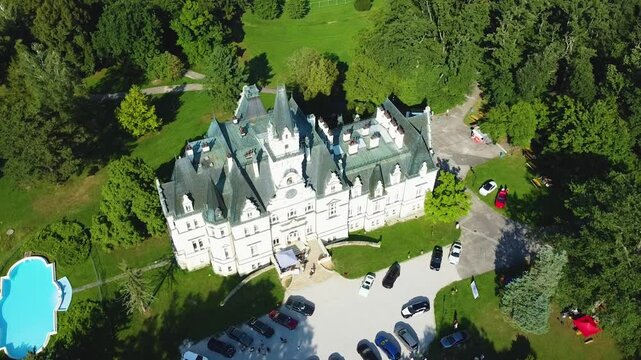 Stunning 4K drone footage of Budmerice Castle in Slovakia. Discover breathtaking aerial views of this picturesque 19th-century castle surrounded by lush greenery and beautiful gardens
