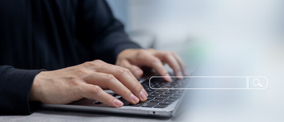 close up businessman hand type on keyboard laptop to surfing the internet by use search engine url...