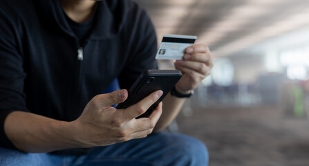 close up adult man holding smartphone  to choose or select items on marketplace website and pay order or reservation by using credit card for modern and comfortable and digital lifestyle concept