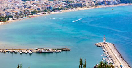 Fototapeta premium Panoramic view of old lighthouse in Alanya port. Landscape view of Mediterranean coast, Alanya, Turkey. High quality photo