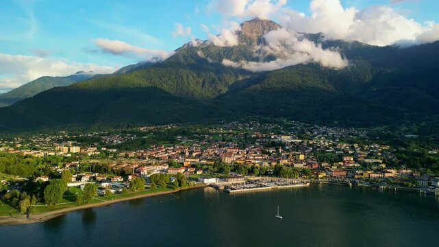 Aerial view of Colico town on Lake Como, Italy, at sunset, with mount Legnone in the background