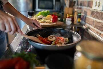 Young woman preparing fresh vegetables in a modern kitchen