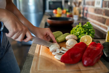 Young woman preparing fresh vegetables in a modern kitchen