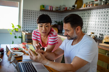 Couple having conversation over breakfast at home