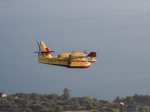 Ponferrada, Leon, Spain; 08-19-2024: Canadair CL-215 amphibious seaplane from the 43rd Air Force Group of the Spanish Air Force preparing for the maneuver to collect water from the Barcena reservoir