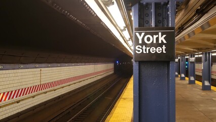 New York City empty subway station interior, underground metropolitan platform sign. Metro railway passenger public transport, United States. Perspective. Text signboard York Street. Brooklyn Downtown