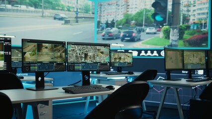 Government satellite CCTV system in empty monitoring room with traffic surveillance via video footage. Public safety on the highways ensured by the national security department offices.