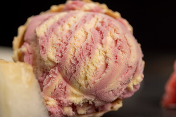 waffle cone with ice cream and pieces of melon and watermelon