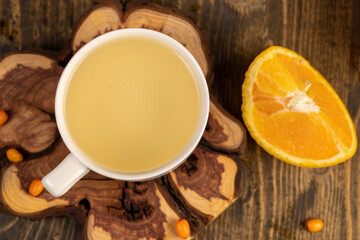 tea with orange and ripe sea buckthorn berries