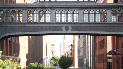 New York City street, Chelsea Market skybridge. Retro industrial architecture, red brick building. American old historic elevated sky bridge Manhattan landmark, USA. Meatpacking district, High Line.