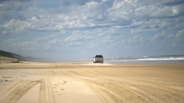 K'gari Fraser Island, Queensland, Australia- 4wd car driving on beautiful 75 mile beach on the east coast.