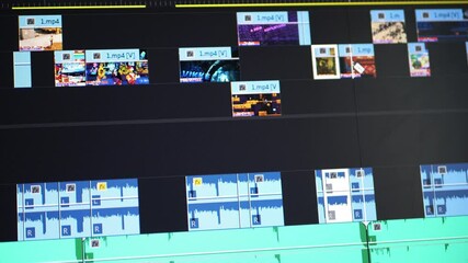 Closeup of computer monitor with video editing timeline. Video editor works on computer. Video processing, post-production - Powered by Adobe