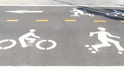 Bike lane asphalt sign, New York City. Bicycle path, cycle route for bicyclists, Manhattan. Way for roller skating and skates. Recreational sport activity infrastructure, biker cycling, United States.