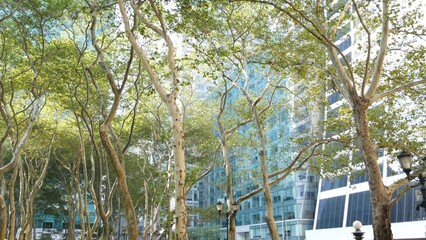 New York City, Manhattan Midtown Bryant Park with Public library, 42 street and 5th Fifth 5 avenue corner, United States. NYC landmark in USA. Trees summer greenery in public park garden. Buildings.