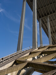 The arch of the Arr&aacute;bida bridge, with the ladder where you can climb to the top of the arch, using harnesses and steel cables. Above, the lower part of the bridge deck supported by pillars. Portugal.
