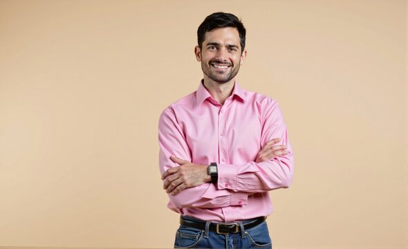color field style HDR photo of breathtaking Photo portrait of folded arms young man in pink shirt business investor satisfied glad receptionist isolated on beige color background , jean pant, look at