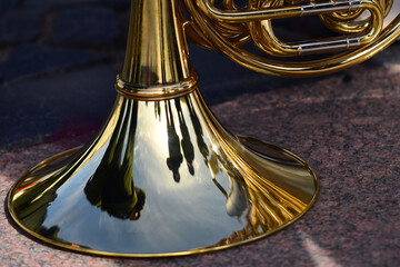 The reflection of Russian military marching band on the French horn in horizontal frame.