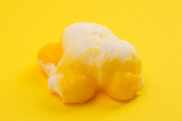 Freeze Dried Lemon Flavored Candy on a Bright Yellow Background
