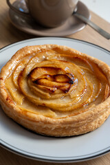 French fresh baked sweet puff pastry with fresh apple fruits in sirup  in confectionery shop