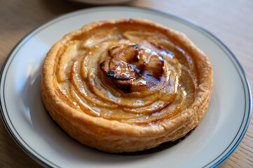 French fresh baked sweet puff pastry with fresh apple fruits in sirup  in confectionery shop