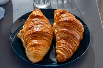 Fresh baked buttered croissants served in restaurant for continental or French breakfast close up
