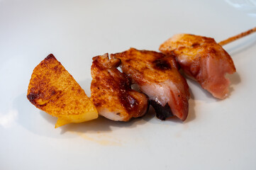 Typical snacks of Basque Country, pinchos or pinxtos skewers with small pieces of bread, fish, sea food, sweet green pepper served in bar in San-Sebastian or Bilbao, Spain