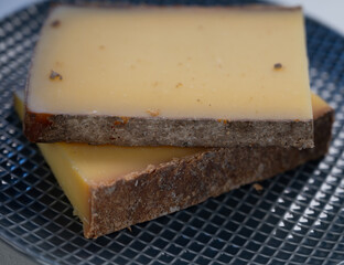 French cheese Comte, varieties unpasteurised ed milk Prestige, fruity flavoured Fruite and Vieille Reserve close up