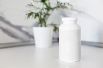 White blank plastic bottle for pills in kitchen interior