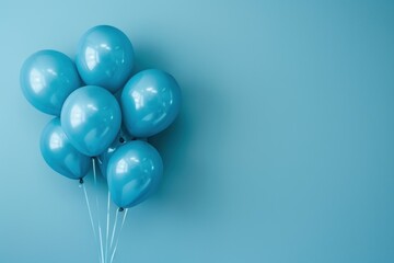 A bunch of light blue balloons against a light blue background.