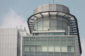 Obraz premium Close-up of a contemporary tower's rooftop with sleek steel structures and a glass facade, showcasing modern architecture with geometric patterns and minimalist design