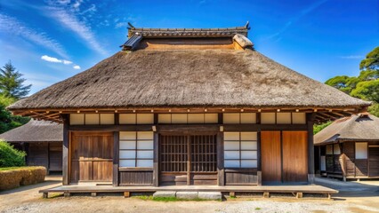 Traditional Japanese house with a thatched roof and paper sliding doors against a clear blue sky , Japan, ancient