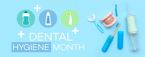 Jaw model with oral irrigator and toothbrushes on blue background