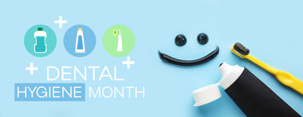 Smile made of black tooth paste, brush and tube on blue background