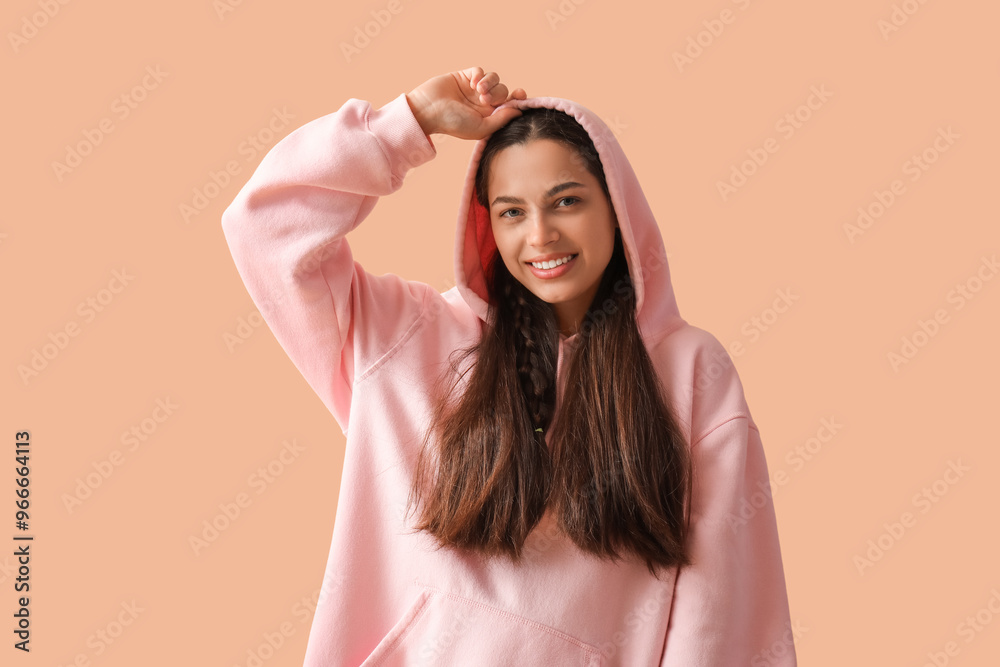 Poster Young brunette woman on beige background