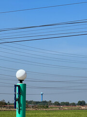 power line and electric poles on green field background