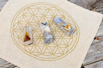 A top view image of three crystal towers on a flower of life grid pattern. 