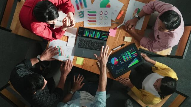 Top down view of business team putting hand together while discussing about Ux Ui design for mobile phone at boardroom. Close up of marketing team making stack of hand and clapping hand. Convocation.