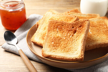 Delicious toasts served on wooden table, closeup