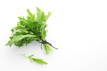 Fresh green arugula leaves on white background, flat lay. Space for text